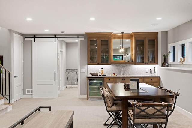 dining room featuring light colored carpet, recessed lighting, baseboards, a barn door, and beverage cooler