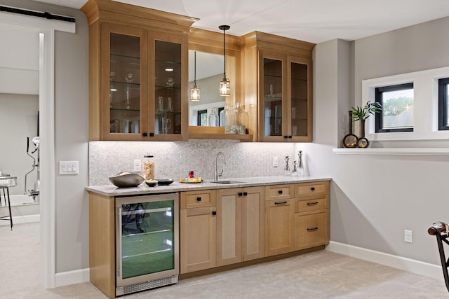 bar featuring backsplash, hanging light fixtures, a sink, beverage cooler, and light carpet