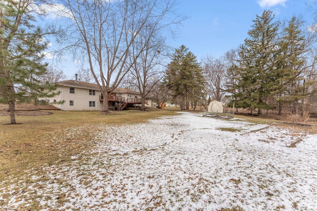 yard covered in snow featuring a wooden deck