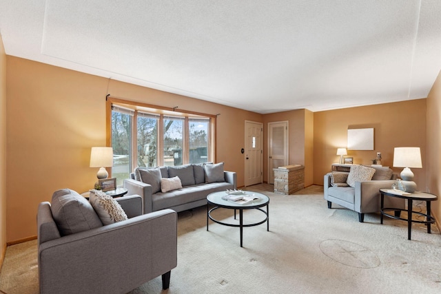 living area featuring light carpet