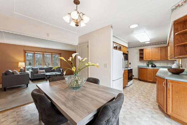 dining area featuring a notable chandelier and light floors