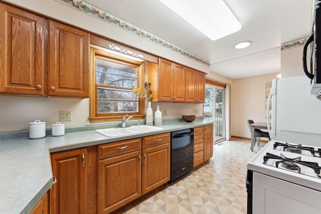 kitchen featuring brown cabinets, a sink, and black appliances