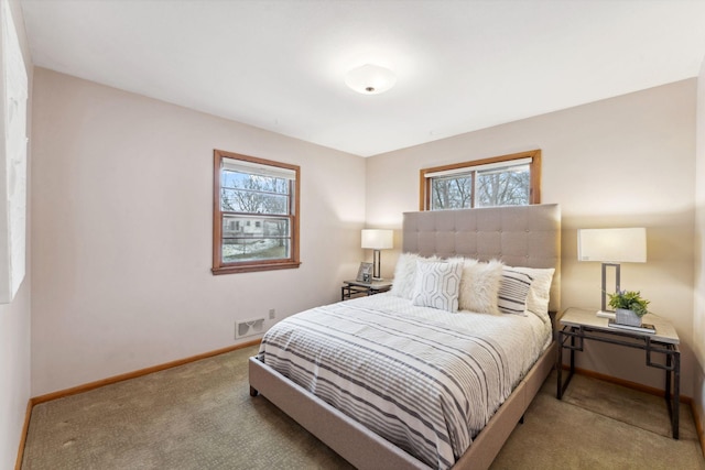 carpeted bedroom featuring visible vents and baseboards