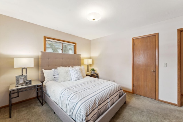 bedroom with baseboards and light carpet