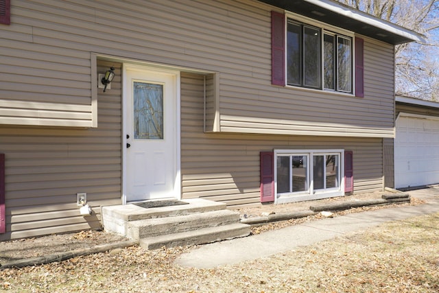 entrance to property featuring an attached garage