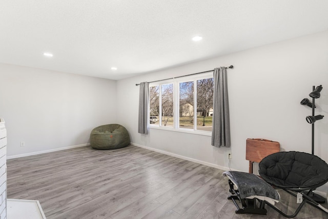unfurnished room featuring wood finished floors, baseboards, and recessed lighting