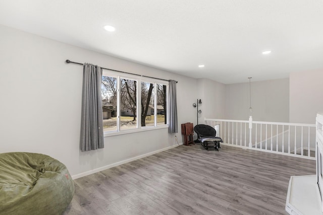 unfurnished room featuring baseboards, recessed lighting, and wood finished floors