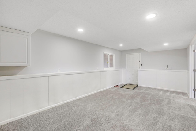 below grade area featuring recessed lighting, wainscoting, and carpet floors