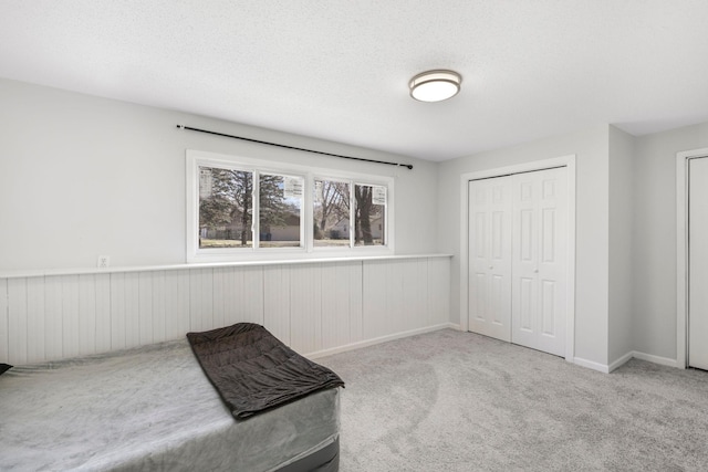 unfurnished bedroom featuring a closet, baseboards, and carpet floors