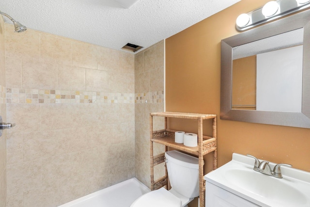 bathroom with a shower stall, a textured ceiling, and toilet