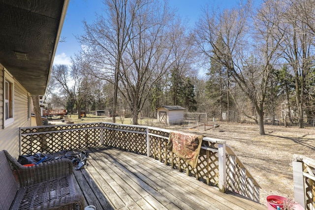 wooden deck featuring an outdoor structure and a shed