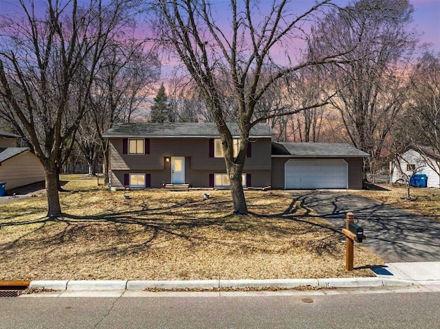bi-level home with a garage and driveway