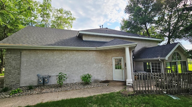 2208 10th Ave SE Unit 12, Willmar, MN 56201 - back of property featuring stucco siding and a shingled roof