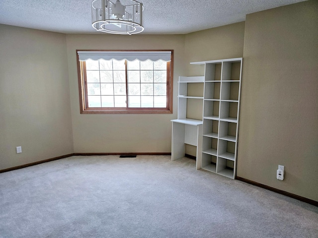 2208 10th Ave SE Unit 12, Willmar, MN 56201 - unfurnished room featuring a chandelier, a textured ceiling, and carpet