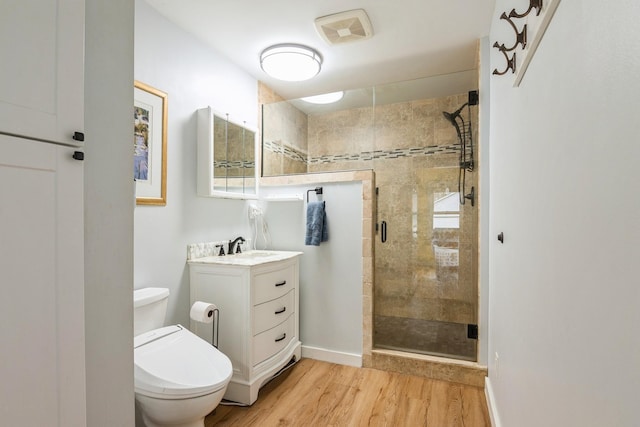 full bath with wood finished floors, toilet, vanity, visible vents, and a stall shower