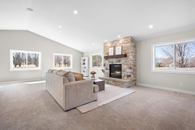 living room featuring a stone fireplace, a wealth of natural light, recessed lighting, and light colored carpet