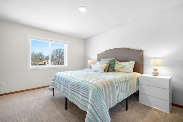 bedroom with baseboards and carpet