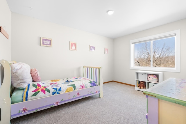 carpeted bedroom featuring baseboards