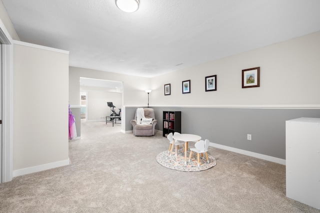 sitting room with baseboards and carpet flooring