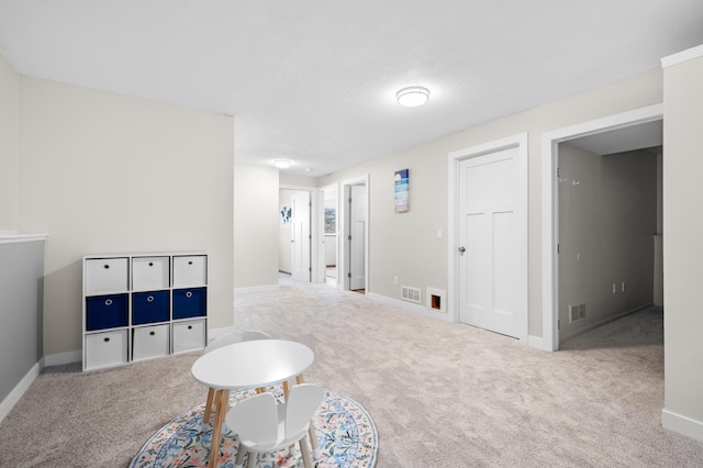 rec room featuring carpet, visible vents, and baseboards