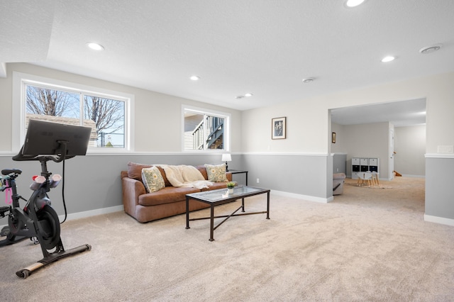 living area featuring carpet, baseboards, and recessed lighting