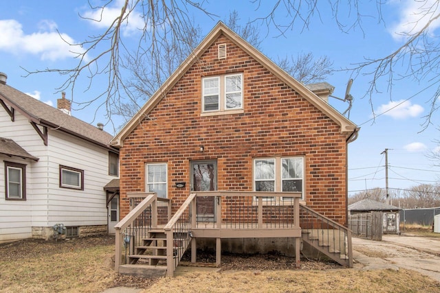 back of house with brick siding, stairway, and a deck