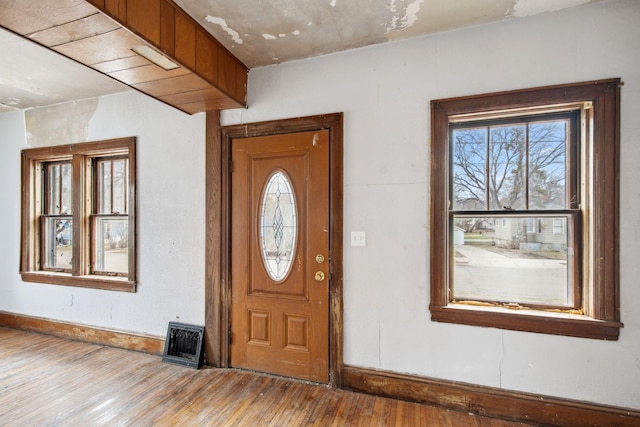 foyer entrance featuring wood finished floors and baseboards