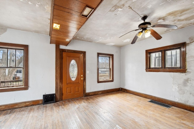 foyer entrance with wood-type flooring, baseboards, and a ceiling fan