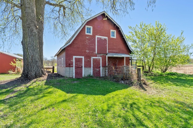 100 Stark Rd, Harris, MN 55032 - back of property with a barn, an outbuilding, a lawn, and a gambrel roof