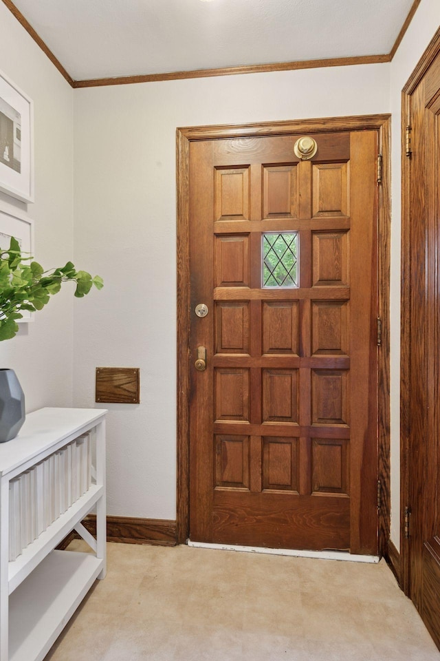 entryway featuring ornamental molding and baseboards