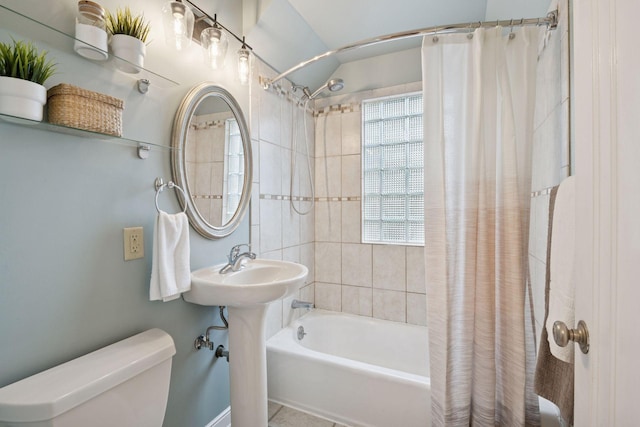 full bathroom featuring shower / tub combo with curtain and toilet