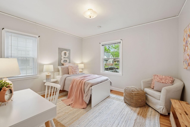 bedroom featuring wood finished floors and baseboards