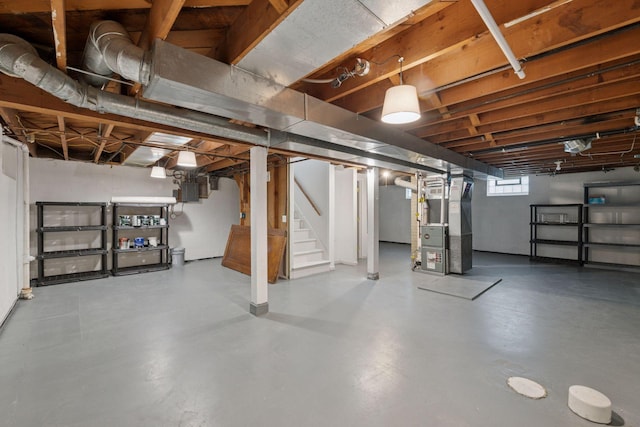 basement featuring stairway and heating unit