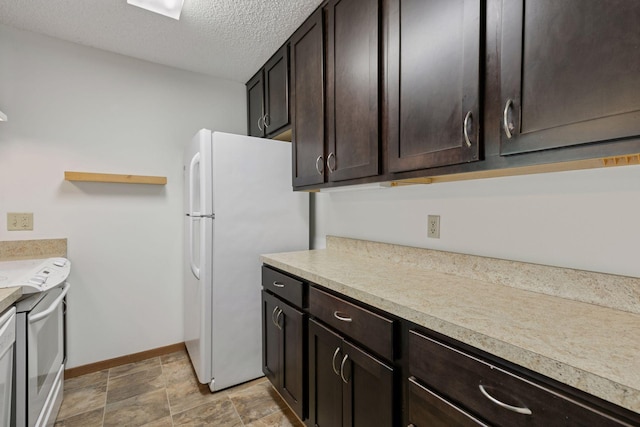 kitchen featuring baseboards, light countertops, a textured ceiling, and dark brown cabinets