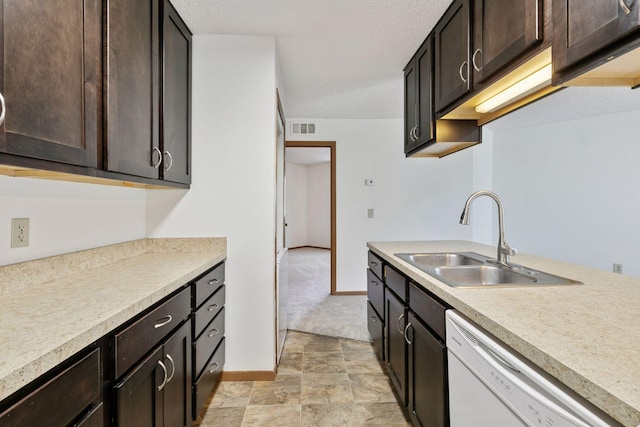 kitchen with a sink, dishwasher, light countertops, baseboards, and visible vents