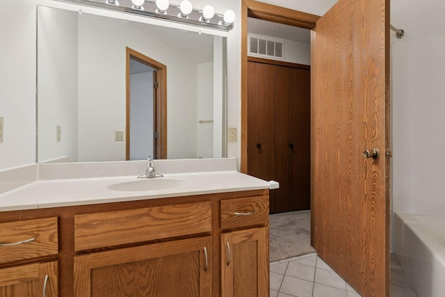 full bath featuring walk in shower, tile patterned flooring, vanity, a tub, and visible vents