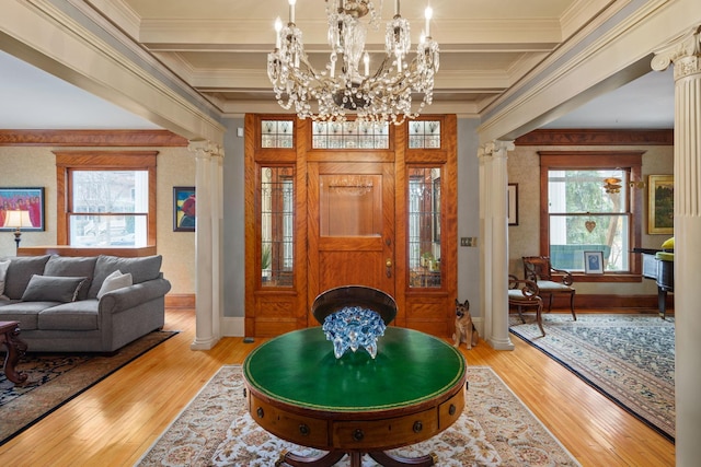 1767 Fremont Ave S, Minneapolis, MN 55403 - entryway featuring ornate columns, light wood finished floors, crown molding, beamed ceiling, and a chandelier