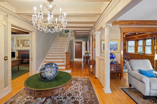 1767 Fremont Ave S, Minneapolis, MN 55403 - entryway with wood finished floors, stairs, a fireplace, beamed ceiling, and ornamental molding