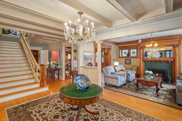 1767 Fremont Ave S, Minneapolis, MN 55403 - living room with wood finished floors, a chandelier, decorative columns, stairway, and beam ceiling