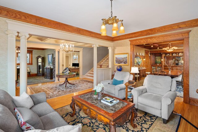 1767 Fremont Ave S, Minneapolis, MN 55403 - living room with a chandelier, hardwood / wood-style flooring, decorative columns, stairs, and ornamental molding