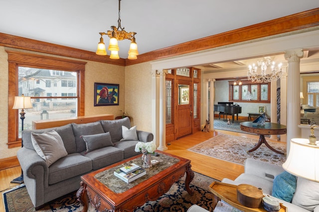 1767 Fremont Ave S, Minneapolis, MN 55403 - living room featuring a chandelier, decorative columns, wood finished floors, plenty of natural light, and crown molding
