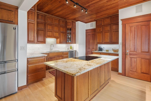 1767 Fremont Ave S, Minneapolis, MN 55403 - kitchen with stainless steel appliances, rail lighting, wooden ceiling, brown cabinetry, and light wood finished floors