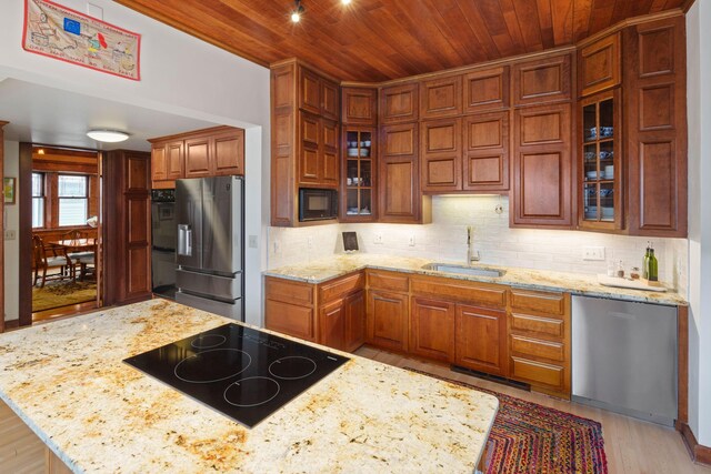 1767 Fremont Ave S, Minneapolis, MN 55403 - kitchen featuring black appliances, wood ceiling, light wood-type flooring, decorative backsplash, and glass insert cabinets