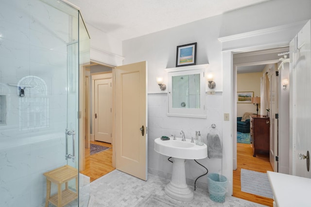 1767 Fremont Ave S, Minneapolis, MN 55403 - ensuite bathroom with wood finished floors, a walk in shower, and tile walls