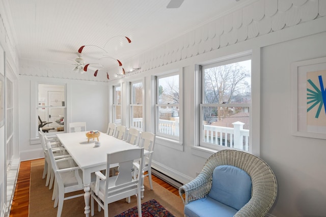 1767 Fremont Ave S, Minneapolis, MN 55403 - dining room featuring wood finished floors, healthy amount of natural light, a baseboard heating unit, and ornamental molding