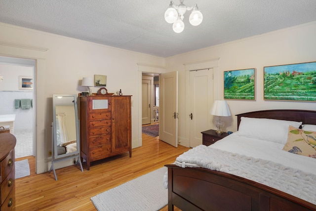1767 Fremont Ave S, Minneapolis, MN 55403 - bedroom with light wood-type flooring, a chandelier, a textured ceiling, and a closet