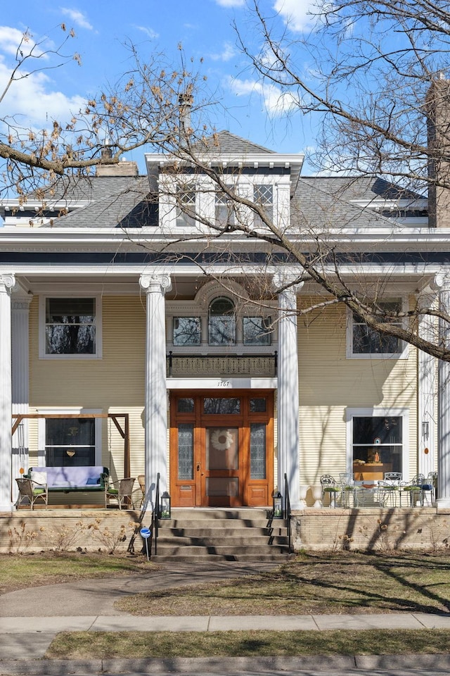 1767 Fremont Ave S, Minneapolis, MN 55403 - doorway to property with a chimney, a shingled roof, and a porch