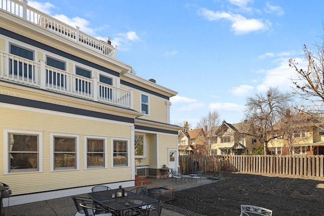 1767 Fremont Ave S, Minneapolis, MN 55403 - rear view of house featuring a fenced backyard, a balcony, and a patio area