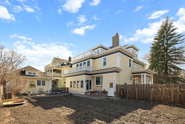 1767 Fremont Ave S, Minneapolis, MN 55403 - rear view of house with a balcony, a patio, and a chimney