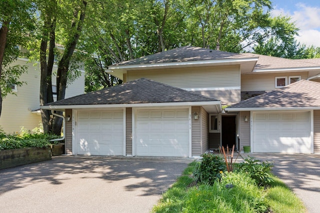 3635 Saint Francis Way Unit B, Eagan, MN 55123 - view of front facade with an attached garage, roof with shingles, and asphalt driveway